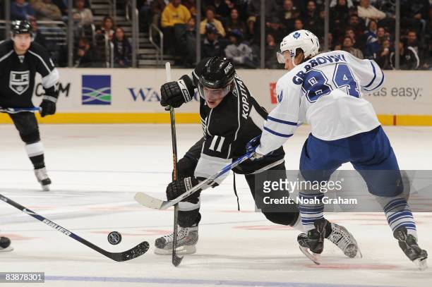 Mikhail Grabovski of the Toronto Maple Leafs defends the puck center ice against Anze Kopitar of the Los Angeles Kings during the game on December 1,...