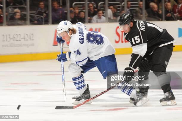 Mikhail Grabovski of the Toronto Maple Leafs drives the puck against Brad Richardson of the Los Angeles Kings during the game on December 1, 2008 at...