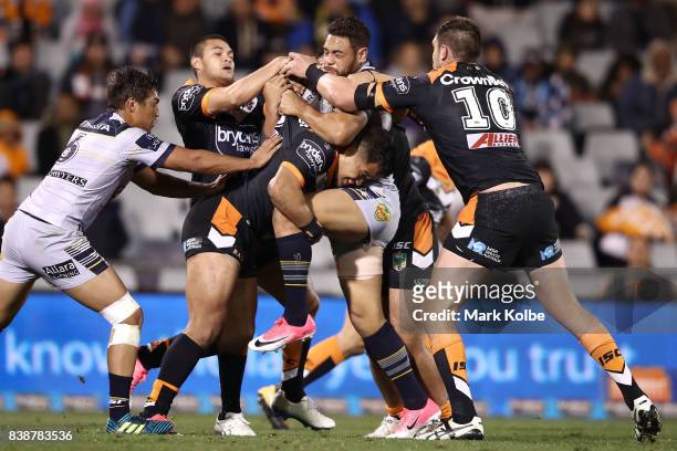 Antonio Winterstein of the Cowboys is tackled during the round 25 NRL match between the Wests Tigers and the North Queensland Cowboys at Campbelltown...