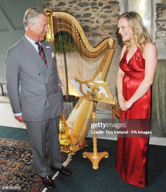 The Prince of Wales speaks with his new official harpist Hannah Stone during a reception for the Cambrian Mountain Initiative at his Welsh farm,...