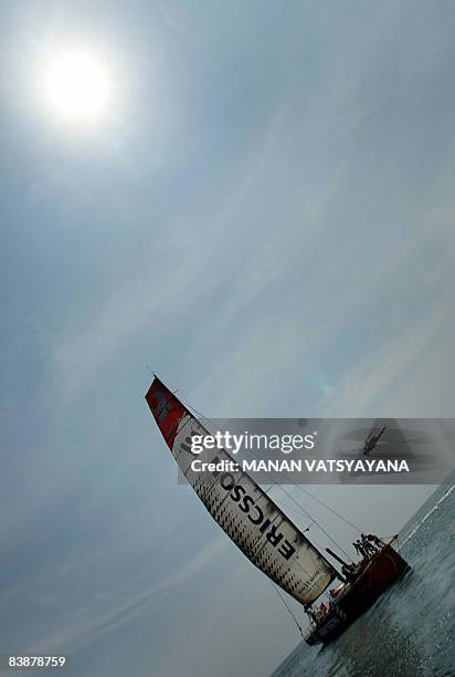 Helicopter flies over as the Ericsson three yacht finishes in third place at Port Cochin in Kochi on December 1 in leg two of the Volvo Ocean Race,...