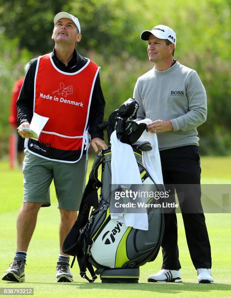 Steve Webster of England speaks with his caddy on the 18th hole during day two of Made in Denmark at Himmerland Golf & Spa Resort on August 25, 2017...