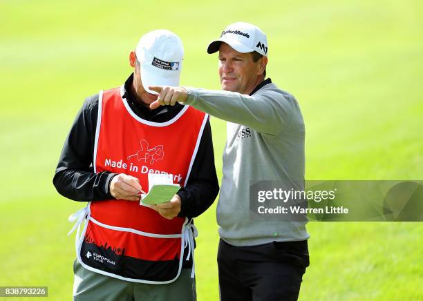 Steve Webster of England speaks with his caddy on the 18th hole during day two of Made in Denmark at Himmerland Golf & Spa Resort on August 25, 2017...