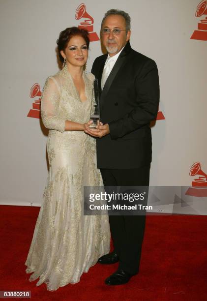 Singer Gloria Estefan and her husband Emilio Estefan pose with her 2008 Latin Recording Academy Person of the Year awards as she arrives for the...