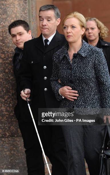 Police officer David Rathband arrives with his wife Katherine and son Ash to give evidence in the Raoul Moat case at Newcastle Crown Court.