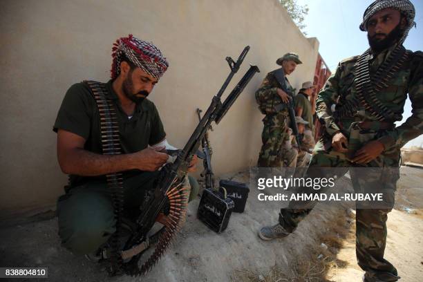 Fighters from the Hashed Al-Shaabi advance inside al-Nour neighbourhood, in eastern Tal Afar, the main remaining stronghold of the Islamic State...