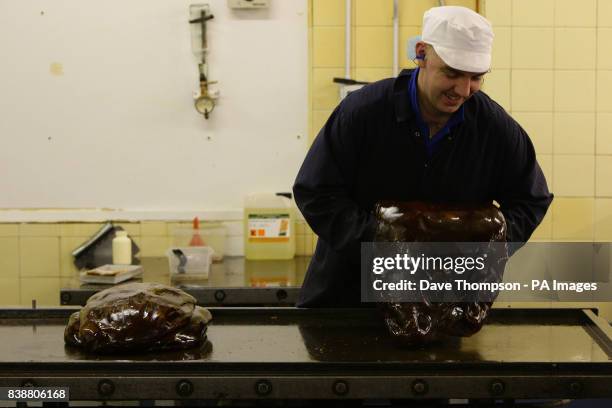 Sugar Boiler Mark James turns the mint mixture at the Santus Toffee Factory in Wigan as they prepare to make the two-billionth Uncle Joe's Mint Ball...