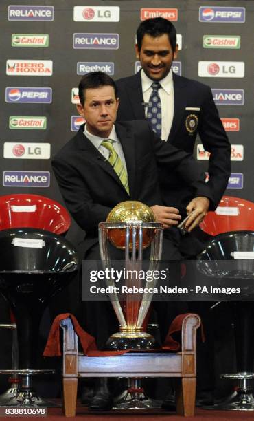 India Captain MS Dhoni and Australia captain Ricky Ponting with the Cricket World Cup trophy, during a press conference at the teams hotel in Dhaka,...