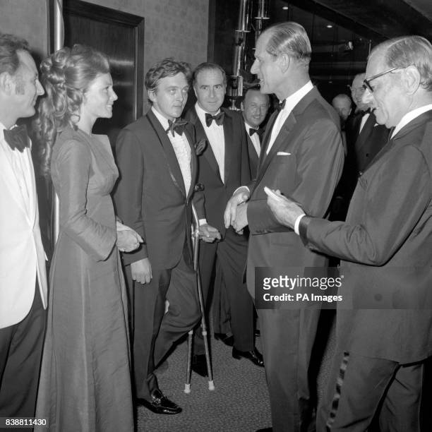 The Duke of Edinburgh talking to Prunella Ransome and actor David Hemmings at the premiere of the film "Alfred the Great".
