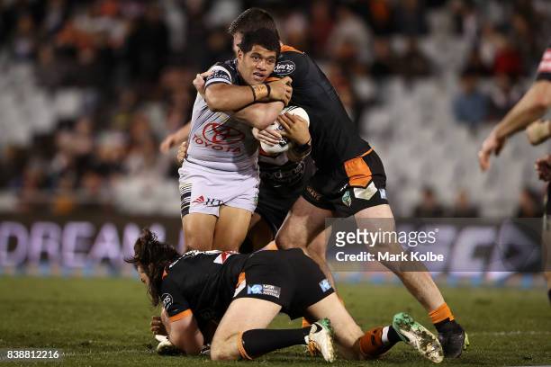 John Asiata of the Cowboys is tackled during the round 25 NRL match between the Wests Tigers and the North Queensland Cowboys at Campbelltown Sports...
