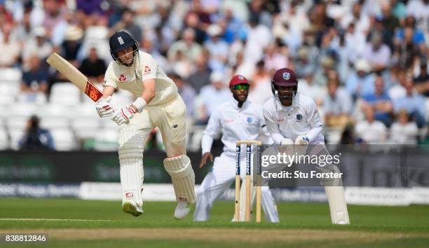 England batsman Joe Root picks up some runs watched by keeper Shane Dowich during day one of the 2nd Investec Test match between England and West...