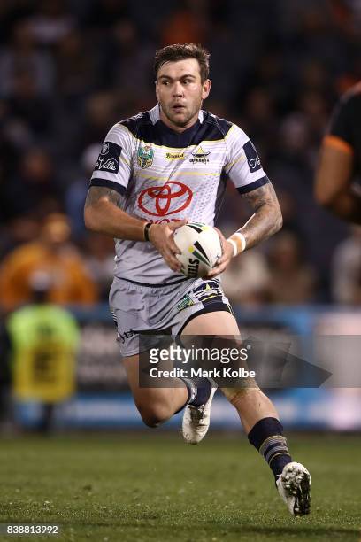 Kyle Feldt of the Cowboys runs the ball during the round 25 NRL match between the Wests Tigers and the North Queensland Cowboys at Campbelltown...