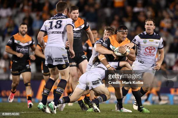 Ava Seumanufagai of the Tigers is tackled during the round 25 NRL match between the Wests Tigers and the North Queensland Cowboys at Campbelltown...