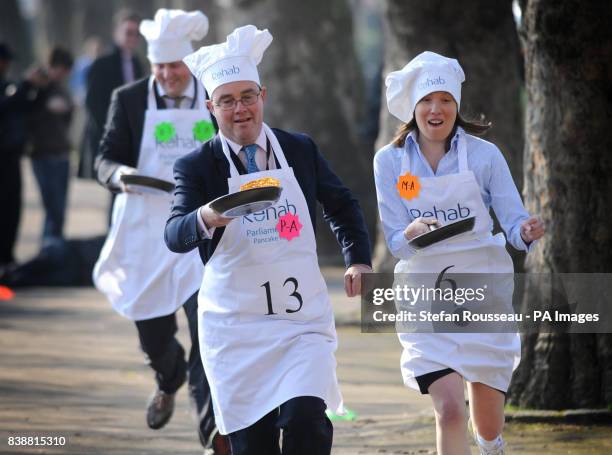 Conservative MP Tracey Crouch and Channel Four Political Editor Gary Gibbon compete in the annual Rehab UK Parliamentary Pancake Race in Westminster,...