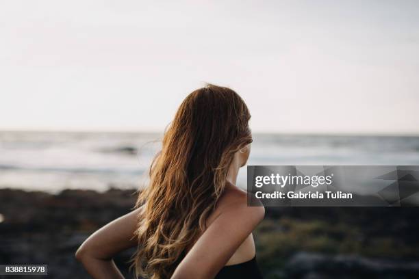 young woman at the beach - beach hair stock-fotos und bilder