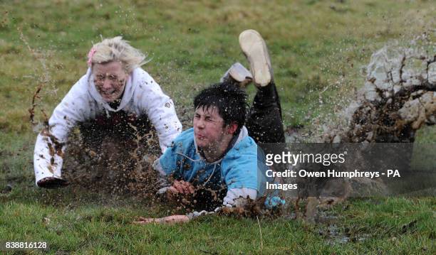 People fall over while participating in the traditional Shrove Tuesday Football match at Alnwick Castle in Northumberland.