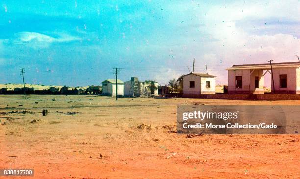 View of outbuilding structures and telephone poles in the desert of Gaza, Israel, November, 1967. .