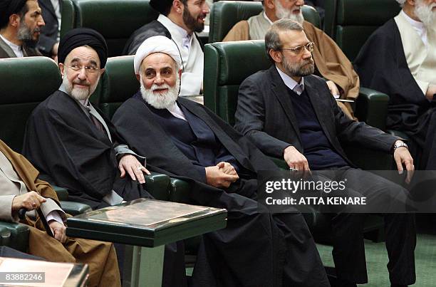 Iranian Parliament Speaker Ali Larijani sits next to former parliament chief Ali Akbar Nategh-Nouri and ex-president Mohammad Khatami during a...