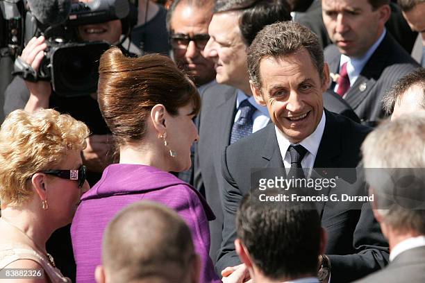 French President Nicolas Sarkozy and wife Carla Bruni-Sarkozy wave to the crowd as they leave the ceremony for Bastille Day, on July 14, 2008 in...