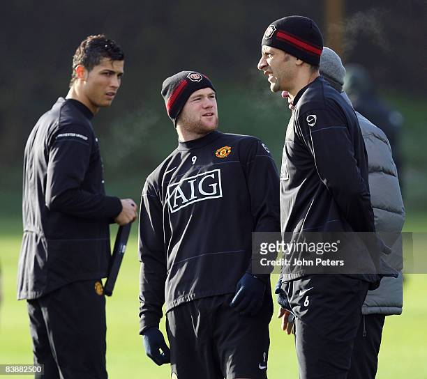 Cristiano Ronaldo, fresh from winning France Football's Ballon D'Or award,Wayne Rooney and Rio Ferdinand of Manchester United in action during a...