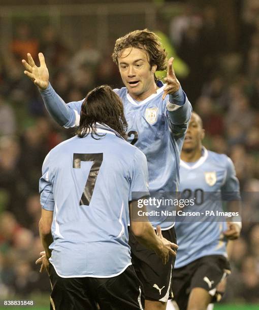 Uruguay's Diego Lugano celebrates with his team-mate Edinson Cavani after scoring his team's opening goal.