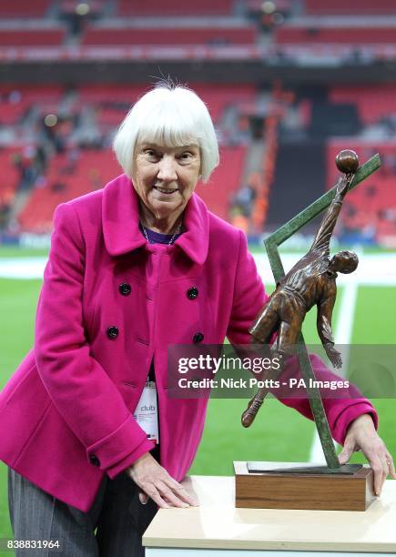 Sheila Leeson poses for the camera with a statue of her grandfather Arthur Wharton, the world's first black professional footballer, prior to kick off