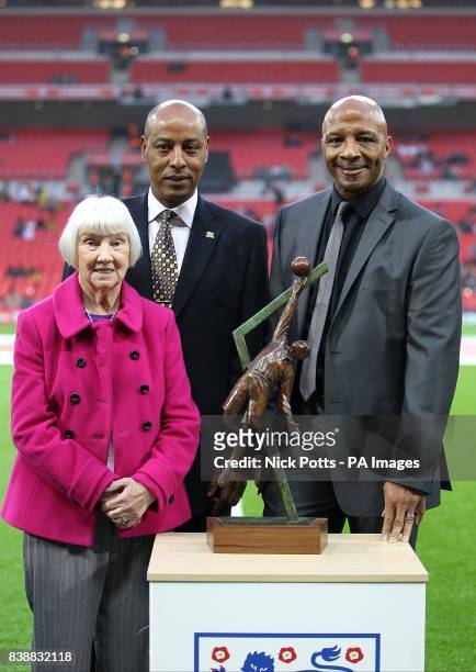 Sheila Leeson poses with Brendon Batson and Cyrille Regis along with a statue of her grandfather Arthur Wharton, the world's first black professional...