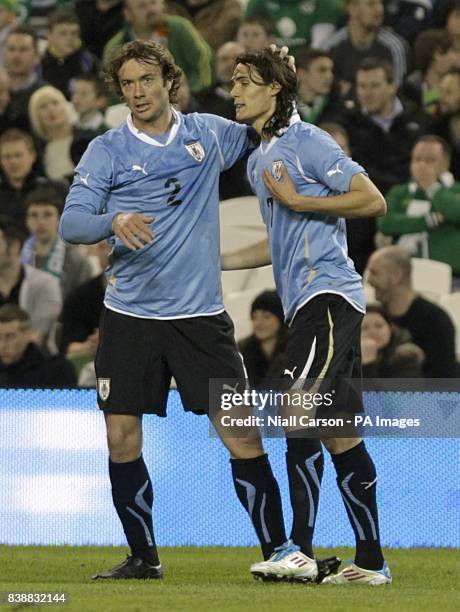 Uruguay's Edinson Cavani celebrates with his team-mate Diego Lugano after scoring his team's second goal.