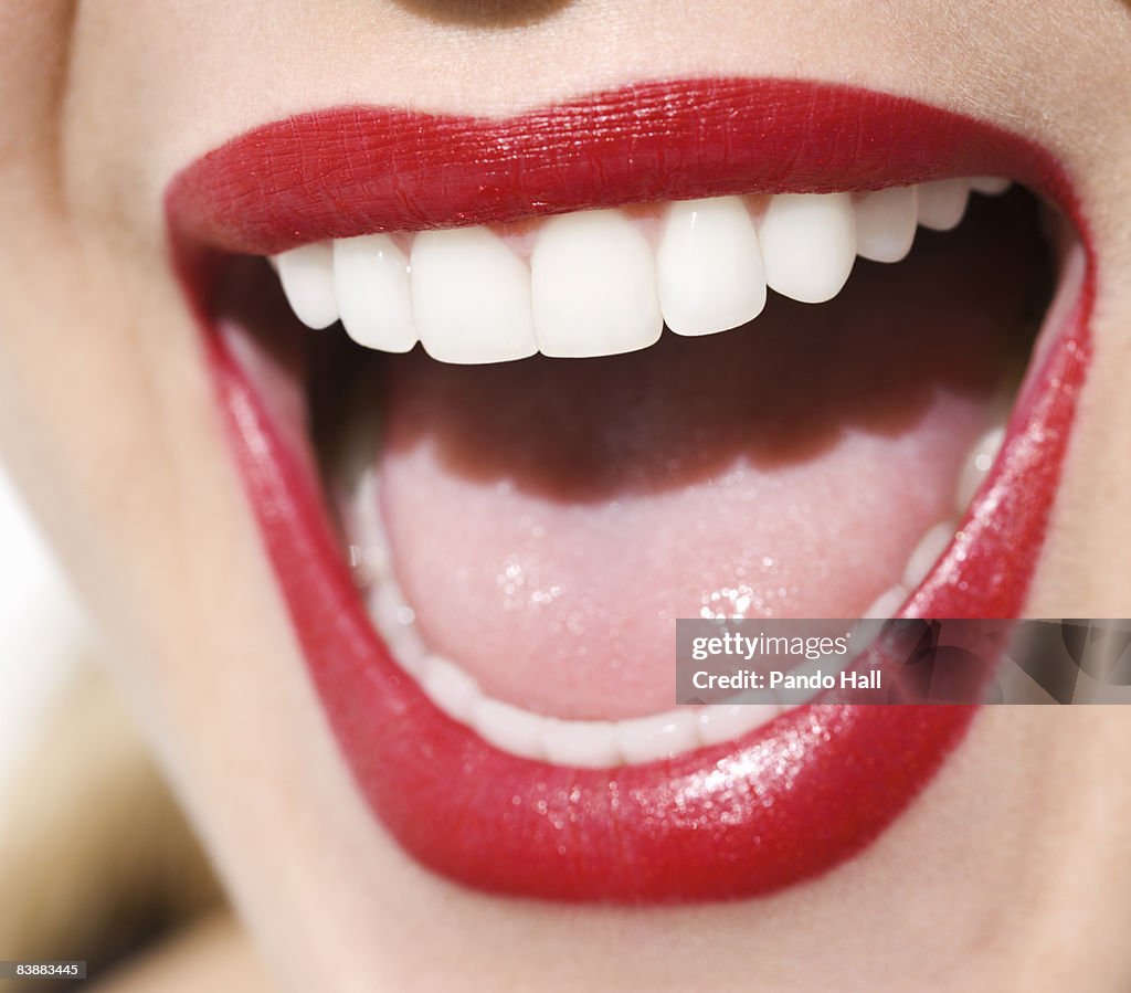 Woman laughing, close-up of mouth, red lips