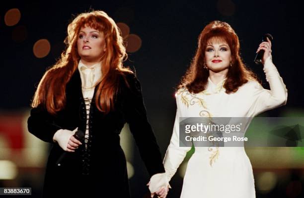 Country singers, Wynonna Judd and her mother Naomi Judd, perform during the half-time show at the 1994 Atlanta, Georgia, Superbowl XXVII football...