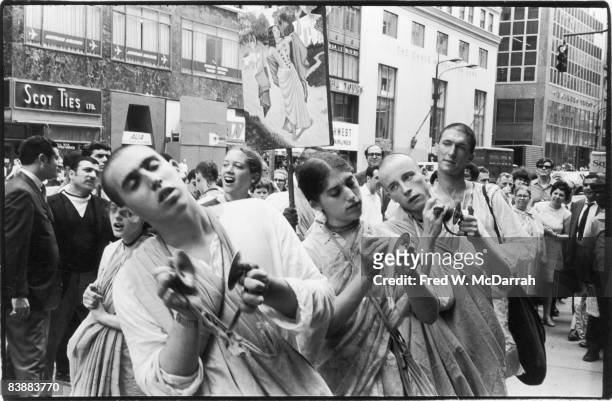 Hare Krishna devotees perform with finger cymbals on the sidewalk of Fifth Avenue, New York, New York, August 2, 1969.