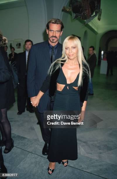Fashion designer Donatella Versace and her husband Paul Beck attend a Bruce Weber retrospective at the National Portrait Gallery in London, 18th...