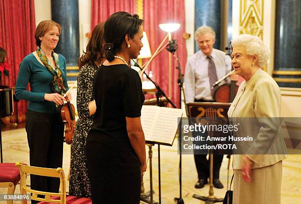 Queen Elizabeth II meets with Condoleezza Rice, the US Secretary of State, as Louise Miliband the wife of the Foreign Secretary David Miliband looks...