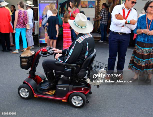 Former U.S. Senator Ben Nighthorse Campbell rides his Pride Victory mobility scooter while visiting the Santa Fe Indian Market in Santa Fe, New...