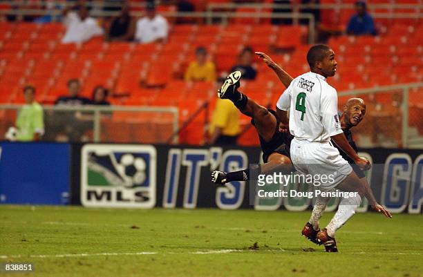 Ali Curtis of D.C. United shoots past Robin Fraser of the Colorado Rapids during the MLS match on June 6, 2002 at RFK Stadium in Washington D.C.. The...