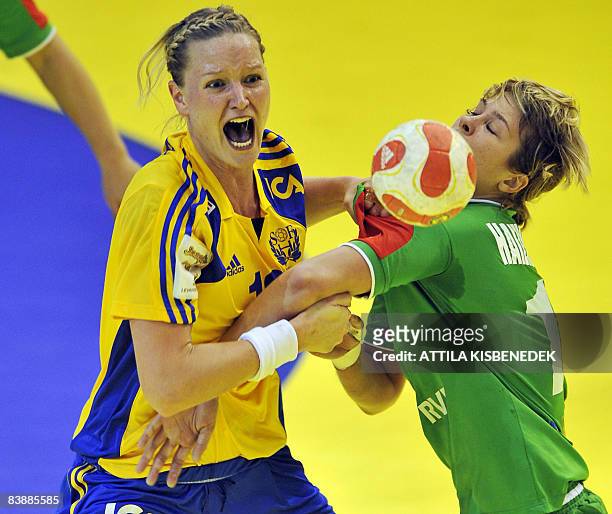 Swedish Therese Utkovic shouts as she vies with Belarus Inhute Haizhutsite during the 8th Women's Handball European Championships group C match match...