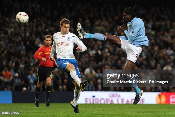 Lech Poznan's Dimitrije Injac and Manchester City's Emmanuel Adebayor battle for the ball