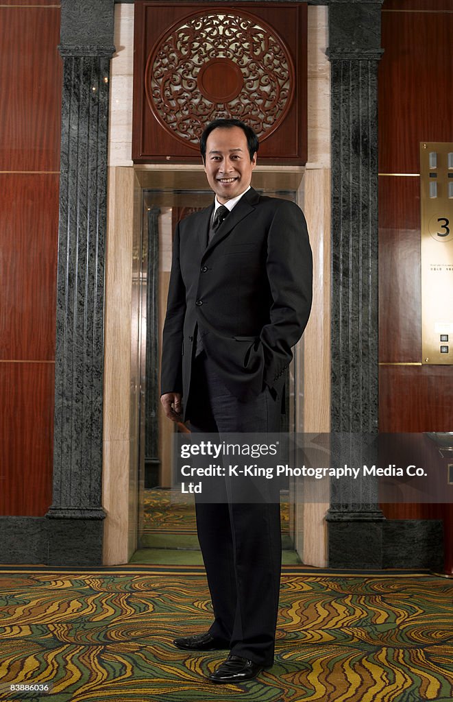 Businessman in lobby of hotel.