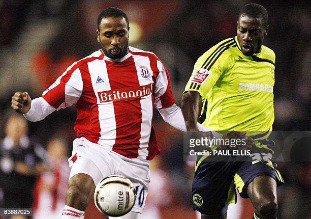 Derby County's English defender Darren Powell closes in on Stoke City's Jamaican forward Ricardo Fuller during their English League Cup quarter final...