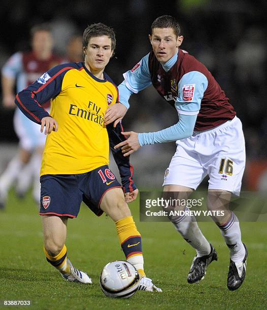 Burnley's Irish midfielder Chris McCann vies with Arsenal's Welsh midfielder Aaron Ramsey during their Carling Cup quater final football match at...