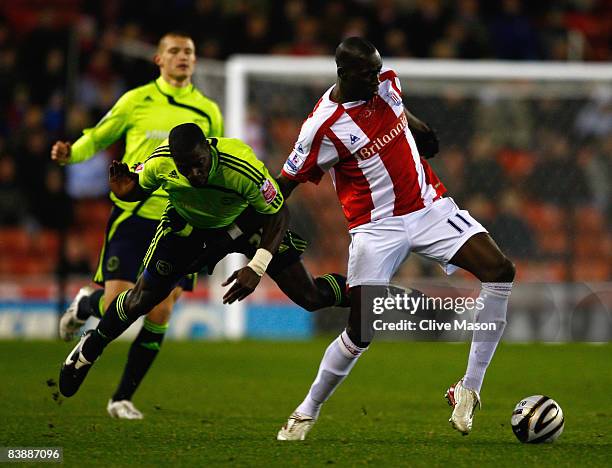 Mamady Sidibe of Stoke is challenged by Darren Powell of Derby during the Carling Cup quarter final match between Stoke City and Derby County at the...