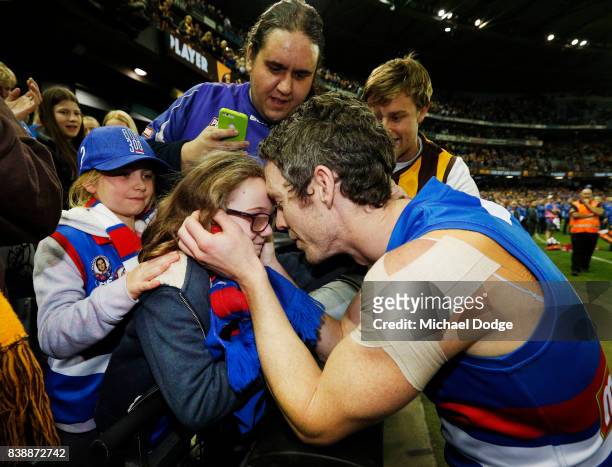 Robert Murphy of the Bulldogs kisses his daughter after his retirement match during round 23 AFL match between the Hawthorn Hawks and the Western...