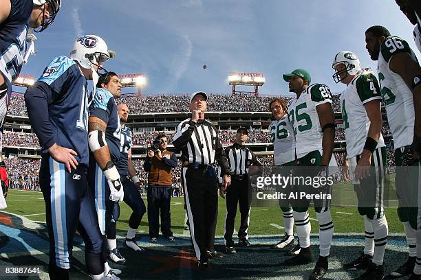 Captains for the Tennessee Titans and the New York Jets participate in the coin toss with Referee Carl Cheffers on November 23, 2008 at LP Field,...