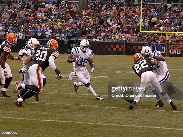 Running back Dominic Rhodes of the Indianapolis Colts returns a kickoff as Jamie Silva and Reggie Wayne block Mike Adams and Brandon McDonald of the...