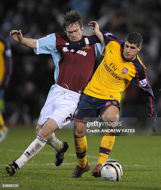 Arsenal's Spanish midfielder Fran Mérida vies with Burnley's Scottish defender Graham Alexander during the Carling Cup quater final football match at...