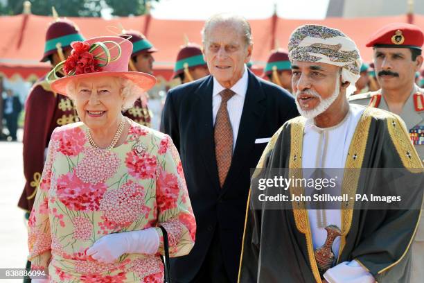 Queen Elizabeth II walks towards her plane with the Sultan of Oman, His Majesty Sultan Qaboos bin Said, before she and the Duke of Edinburgh depart...