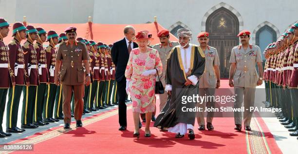 Queen Elizabeth II walks towards her plane with the Sultan of Oman, His Majesty Sultan Qaboos bin Said, before she and the Duke of Edinburgh depart...