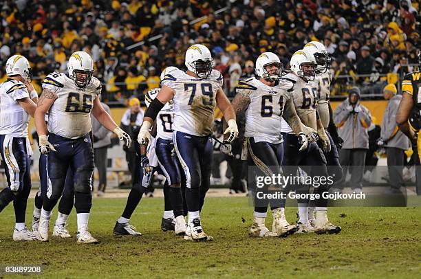 Offensive linemen Jeromey Clary, Mike Goff, Nick Hardwick, Kris Dielman and Marcus McNeill of the San Diego Chargers walk to the line of scrimmage...