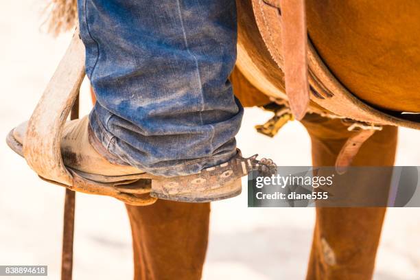 closeup of a cowboy's boot in a stirrup - stirrup stock pictures, royalty-free photos & images