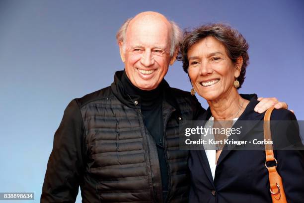 Image has been digitally retouched.) Willy Bogner and wife Sonia Bogner arrive at the 'Eddie the Eagle' premiere on March 20, 2016 in Munich, Germany.